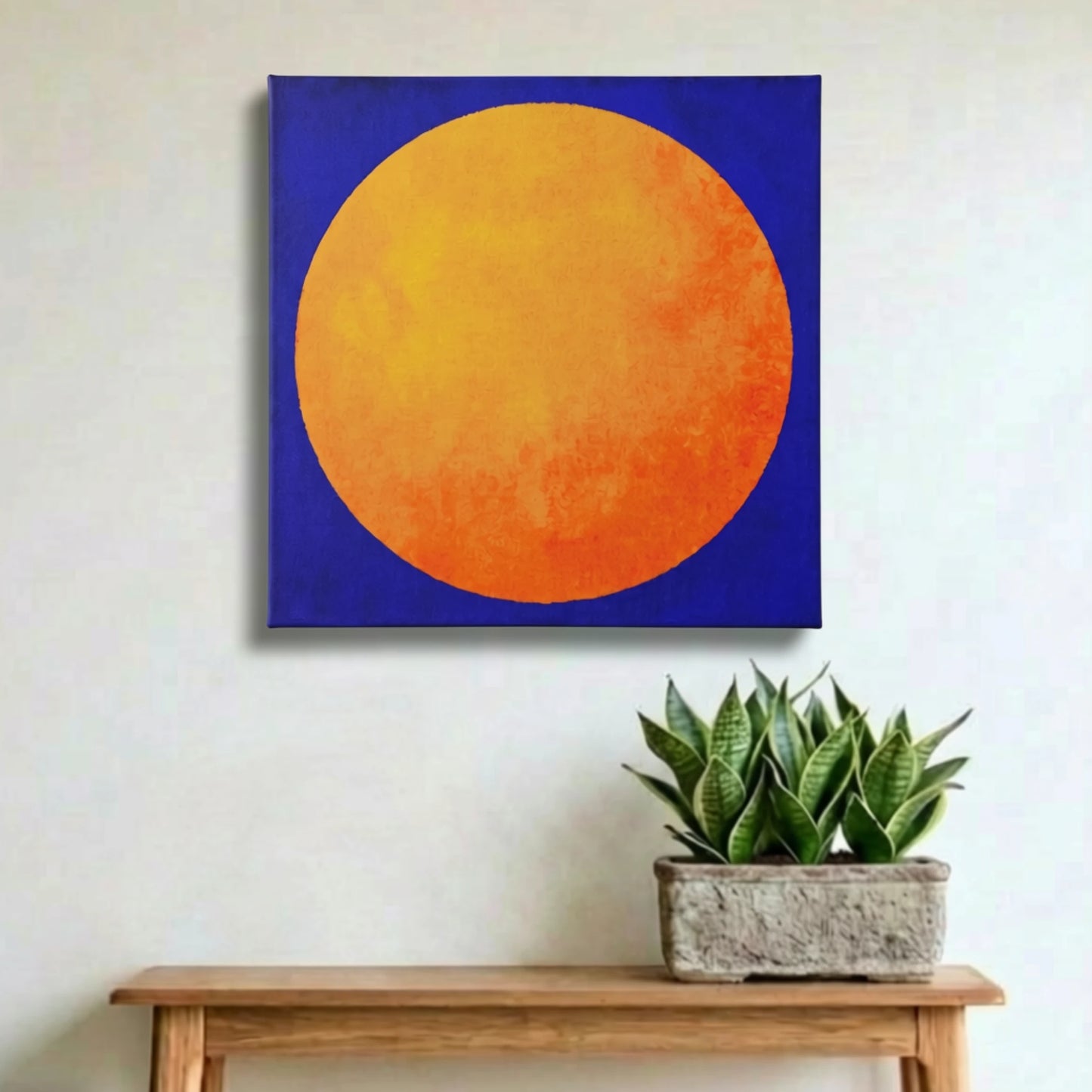 Nature wall art sunrise print in hallway above timber console with potted plants and natural textures