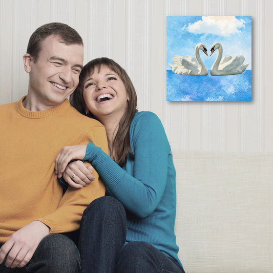 Couple sitting together on couch with Buddha wall art, cozy home decor.