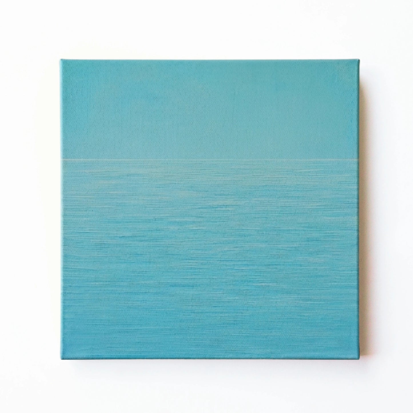 Blue ocean wall art print by RoomFruit, calm aqua water surface on square printed canvas, Australian made