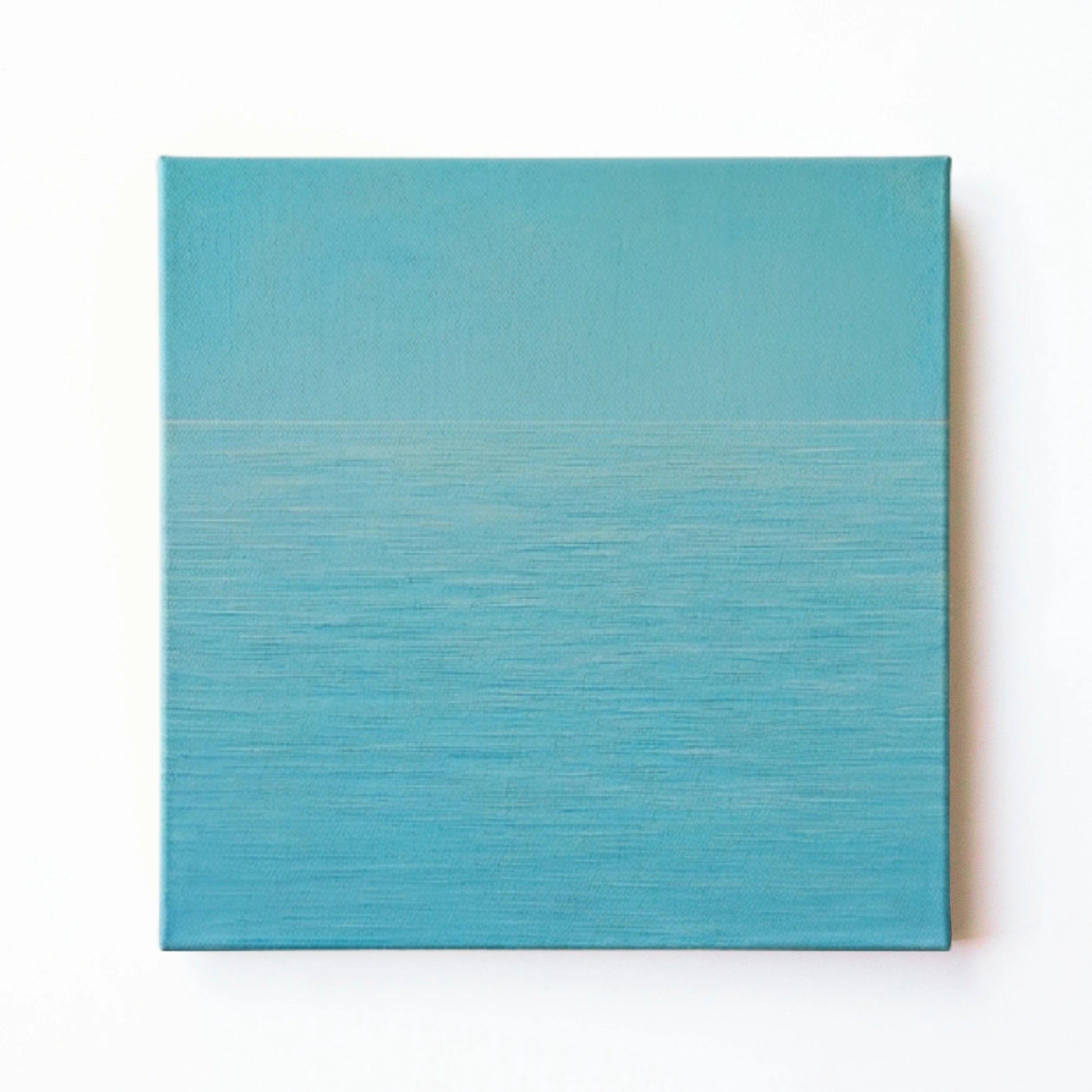 Blue ocean wall art print by RoomFruit, calm aqua water surface on square printed canvas, Australian made