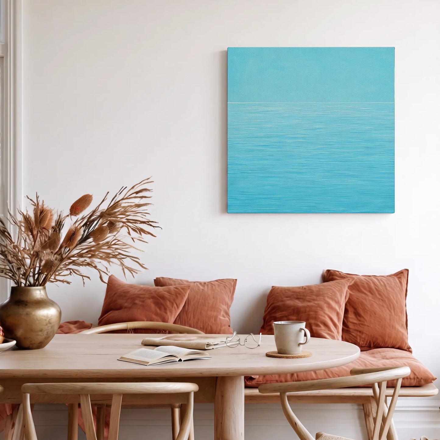 Calming wall art for living room, ocean canvas with tan leather sofa, timber credenza, and round jute rug