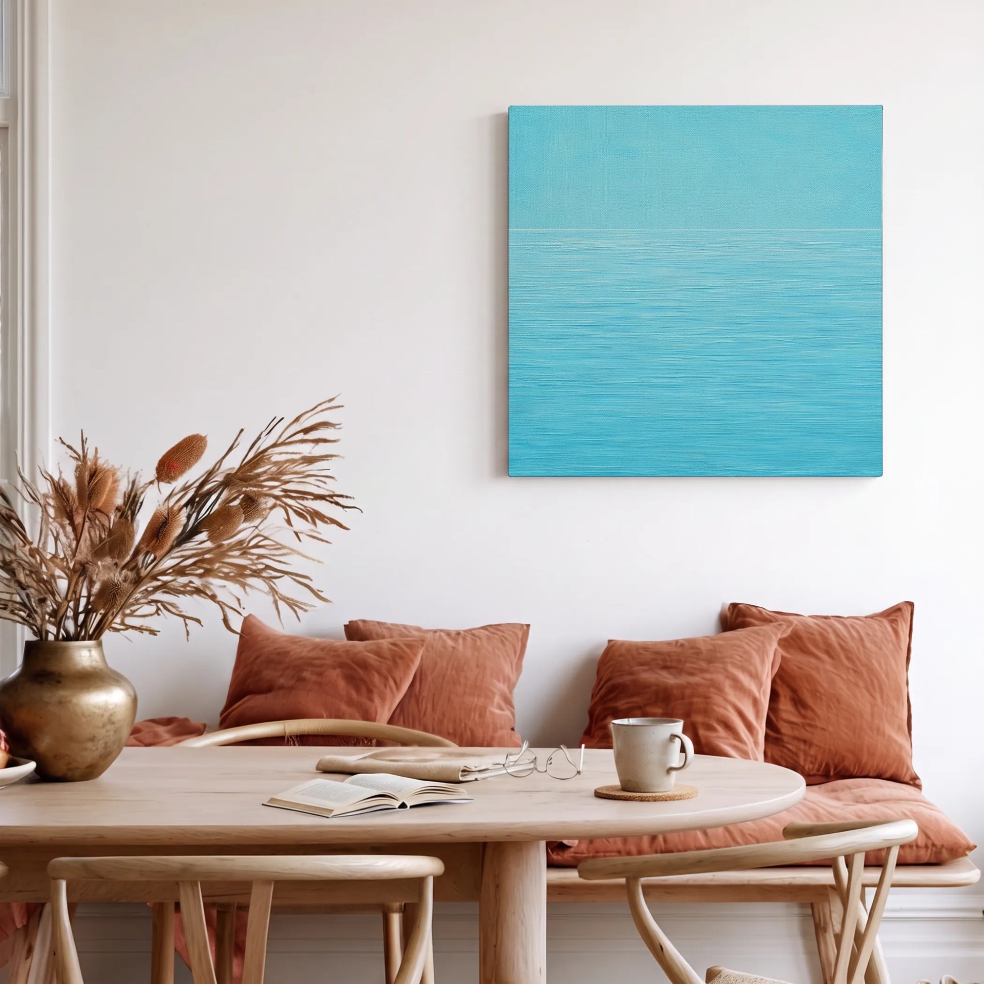 Calming wall art for living room, ocean canvas with tan leather sofa, timber credenza, and round jute rug