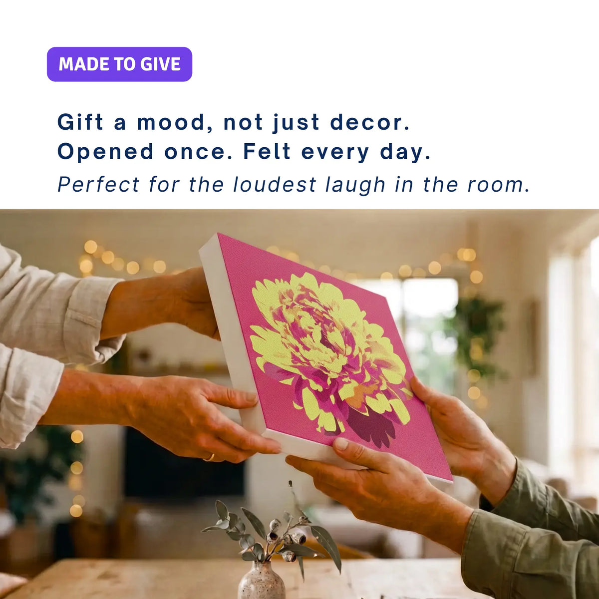 Christmas canvas wall art gift: hands passing ALIVE Peony across a table, fairy lights behind