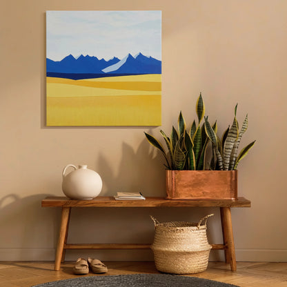 Landscape wall art mountain print in hallway above timber console with snake plant and woven basket