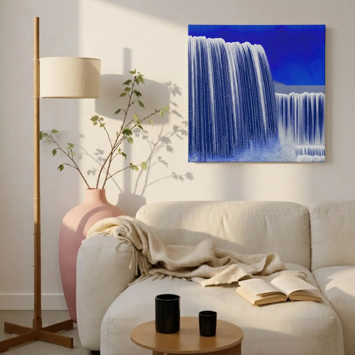 Blue and white nature canvas wall art, POUR Waterfall, above the sofa in a living room