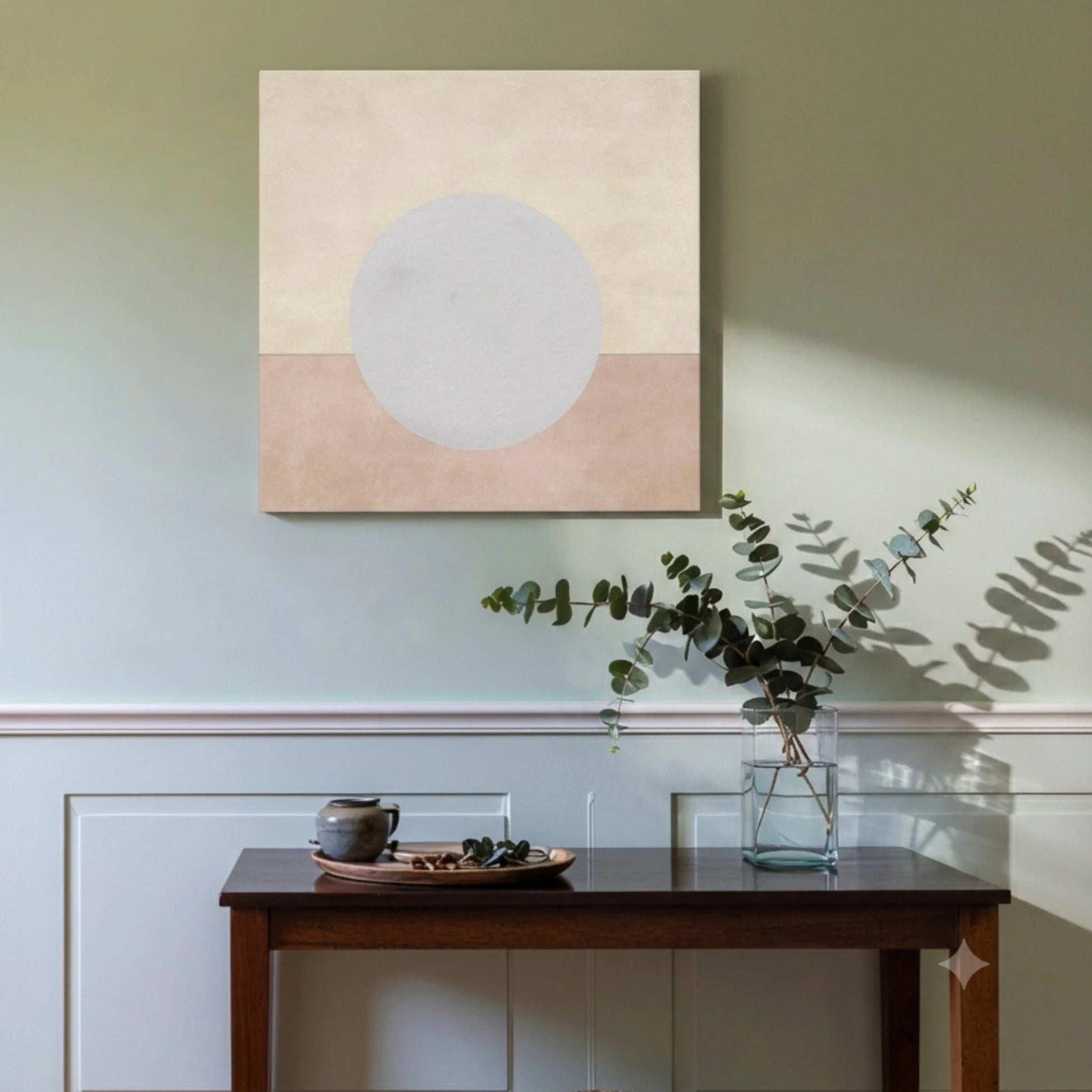 Peaceful wall art moon canvas in living room with sage green wall, dark timber sideboard, and eucalyptus vase