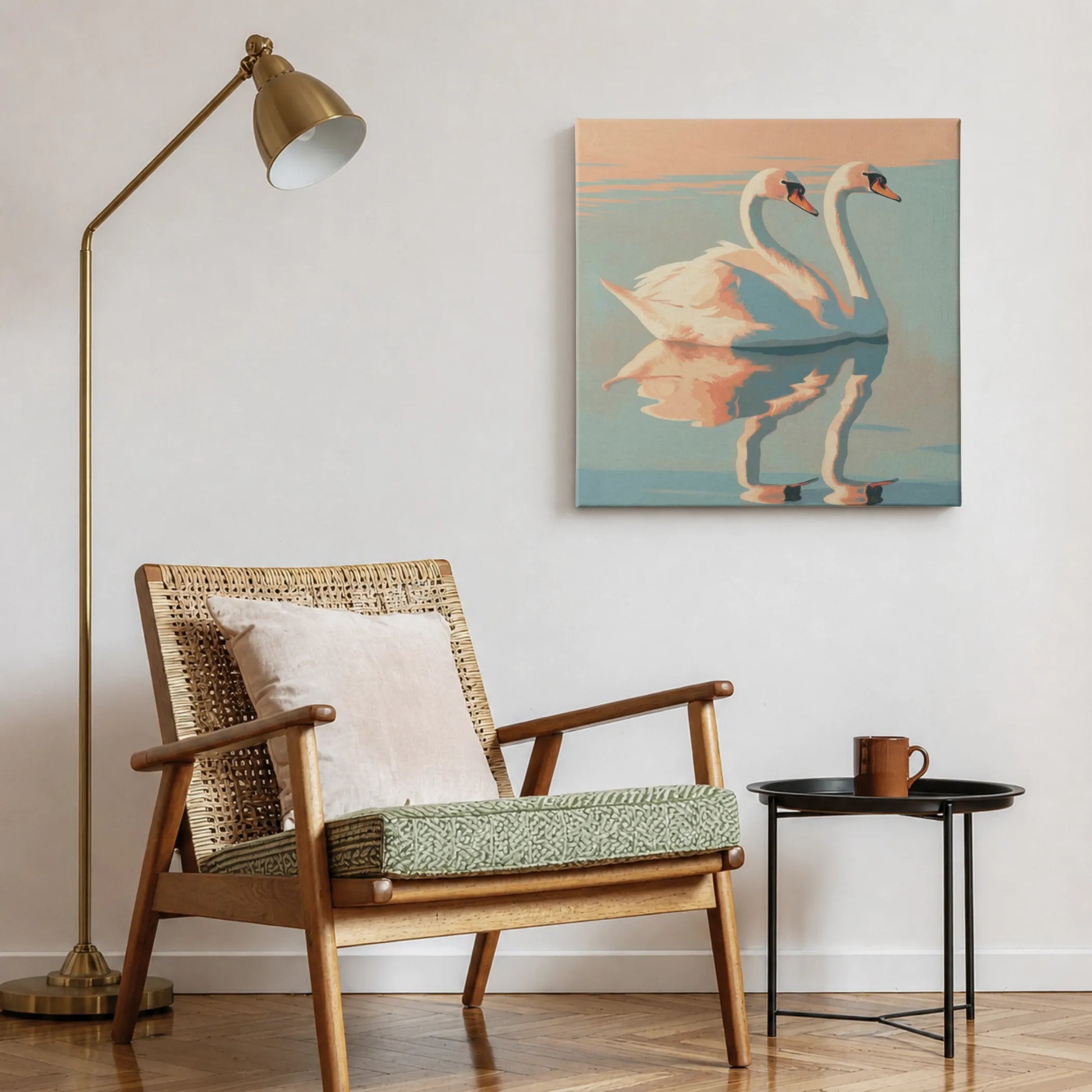 Pink wall art swan print in reading nook with woven accent chair, indoor plant, and warm natural light