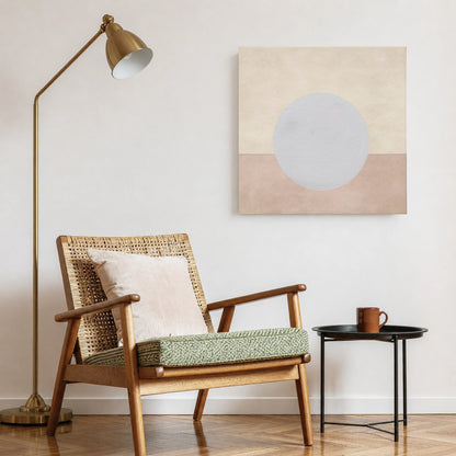 Relaxing wall art moon canvas in reading nook with woven accent chair, modern side table, and brass lamp light