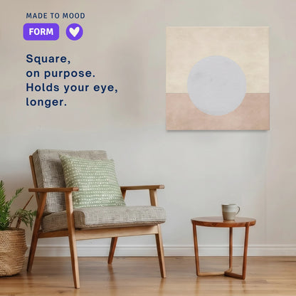Square modern canvas wall art: ENOUGH Moon hung beside an armchair in a calm room