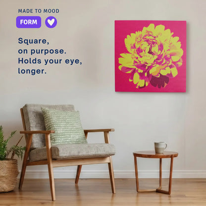 Square modern canvas wall art: ALIVE Peony hung beside an armchair in a calm room