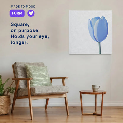 Square modern canvas wall art: LINGER Tulip hung beside an armchair in a calm room