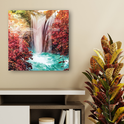Canvas print of a waterfall surrounded by trees with autumn colors on a wall above a desk. 